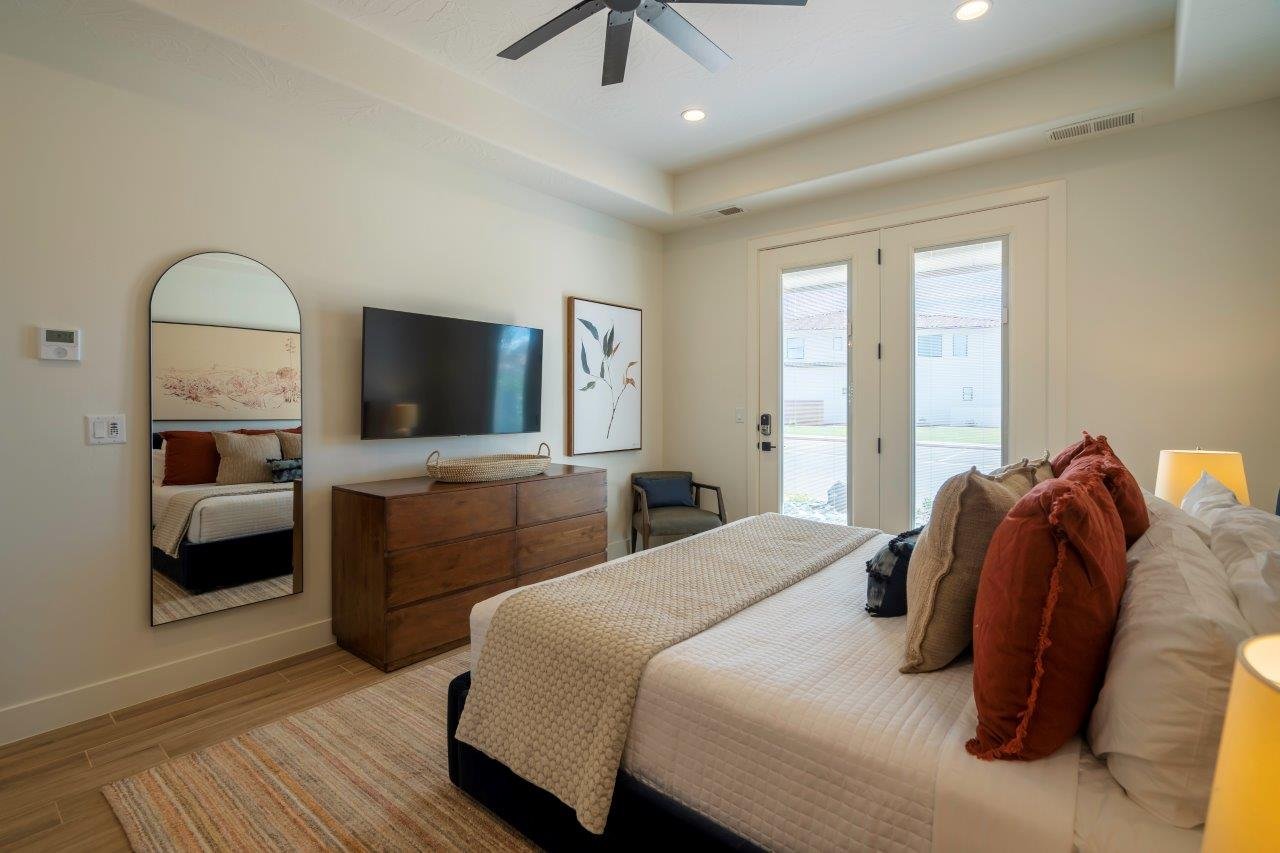 Recessed lighting illuminates this bright room featuring a ceiling fan, French doors with integrated blinds, and wood-finish flooring