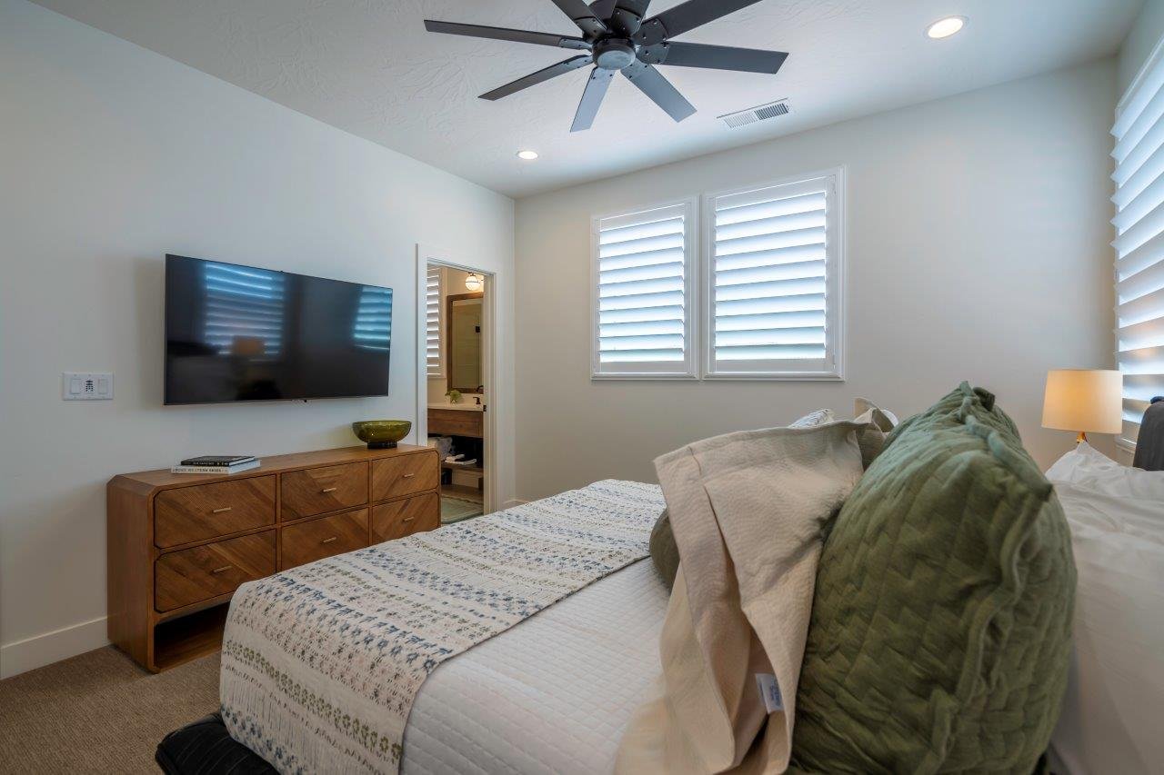 Bedroom featuring plantation shutters, recessed lighting, and a ceiling fan