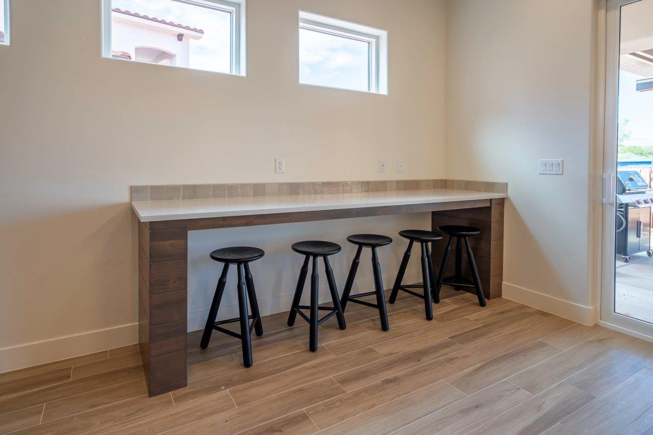 Breakfast bar with a light-colored countertop and tiled backsplash