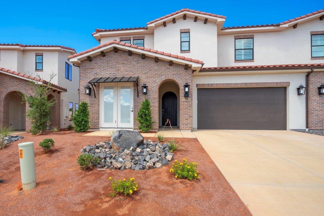 Spanish Colonial Revival architecture with a brick facade accent and stucco finish