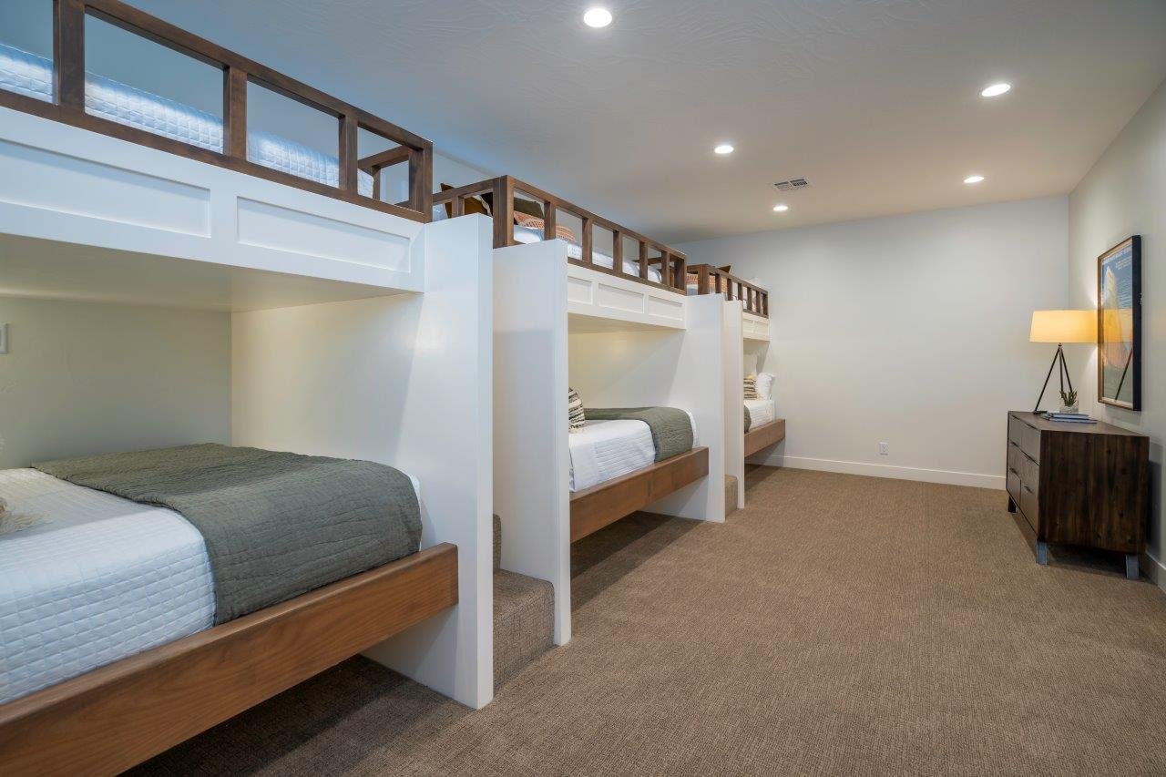 Custom built-in bunk beds featuring wood-finish frames and white paneled bases