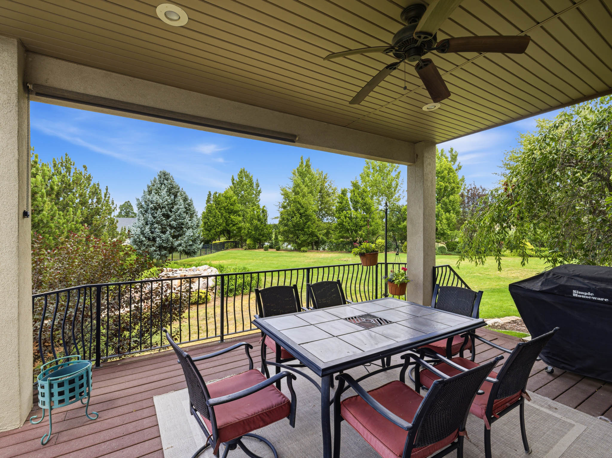 Covered outdoor patio featuring a ceiling fan with integrated lighting, recessed ceiling lights, and wood-finish decking