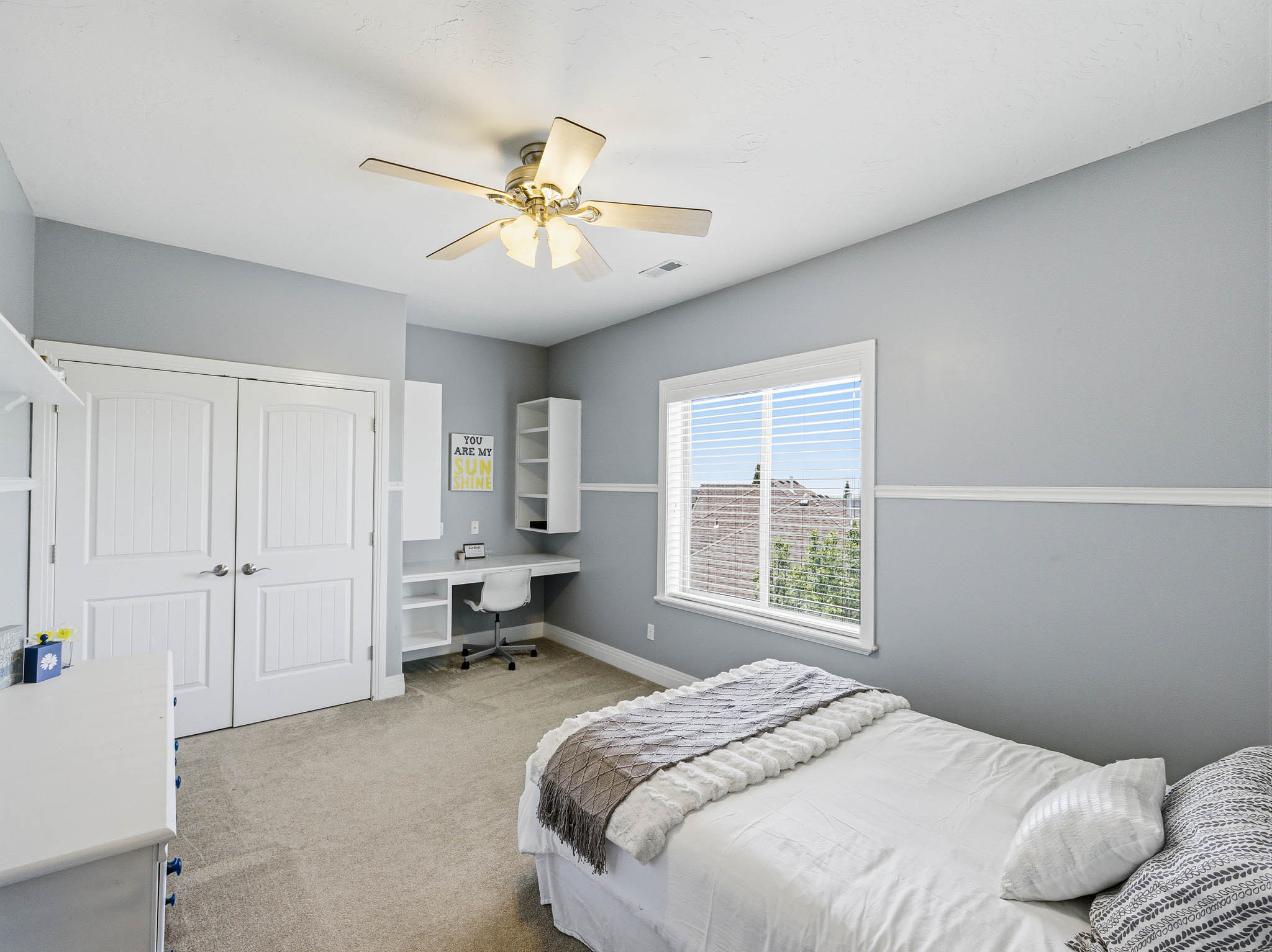 Room featuring light gray walls, white trim, and light-colored carpet