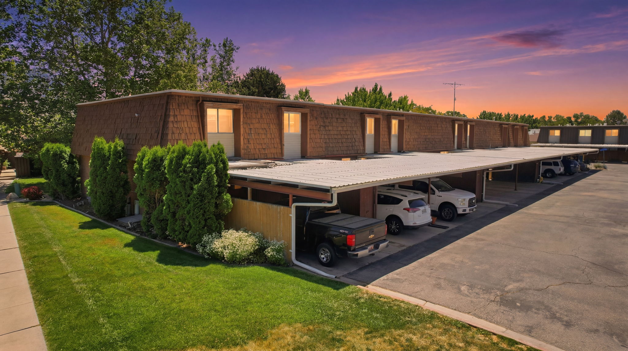 Multi-unit property featuring shake siding and a flat roofline