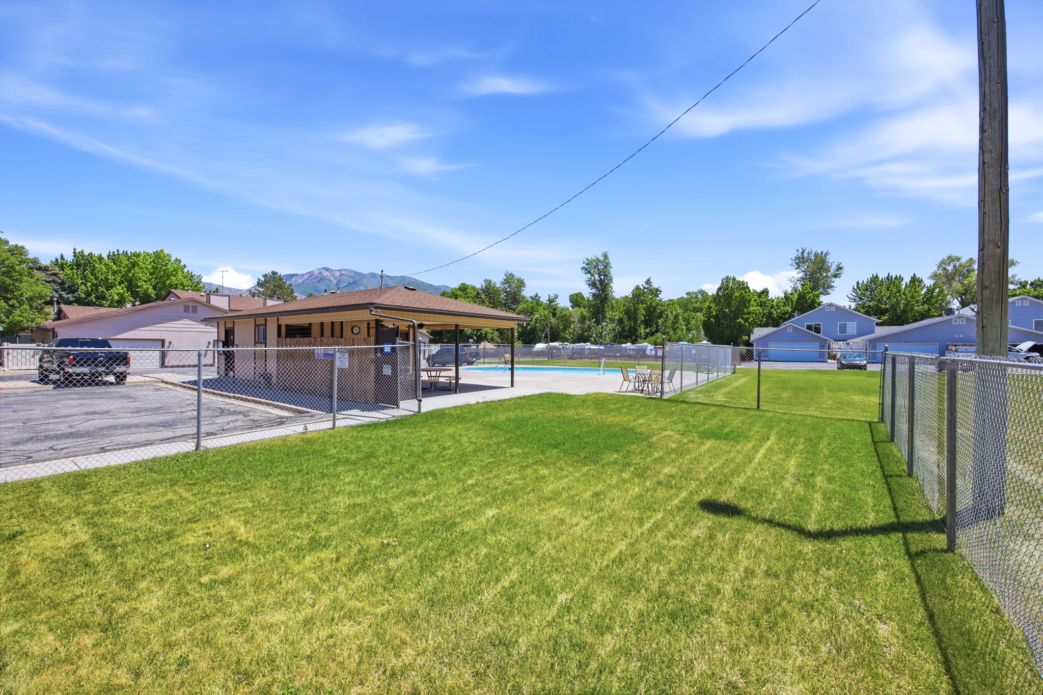Expansive grassy area with chain-link fencing