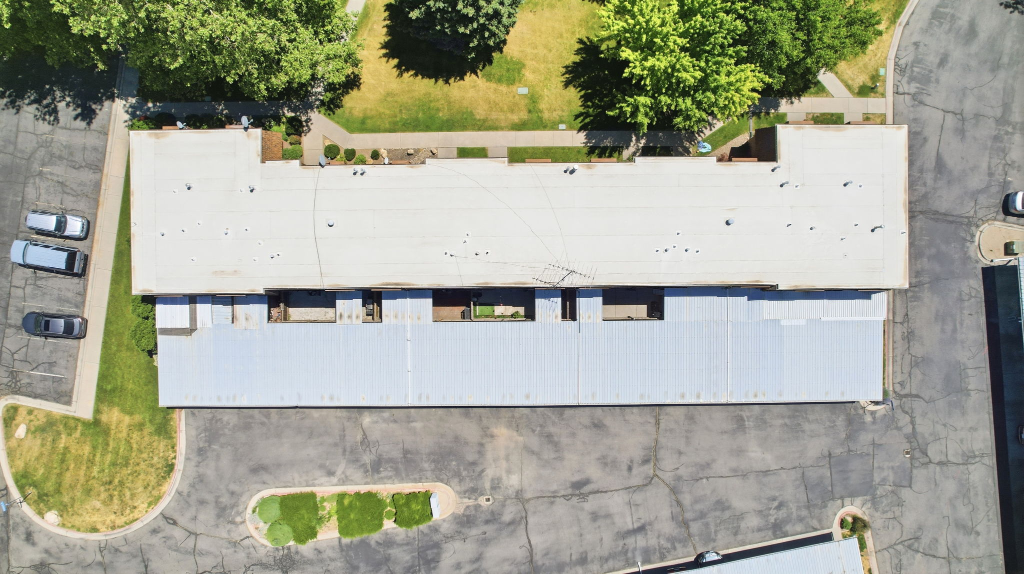 Multi-unit building featuring a flat roofline and integrated covered parking