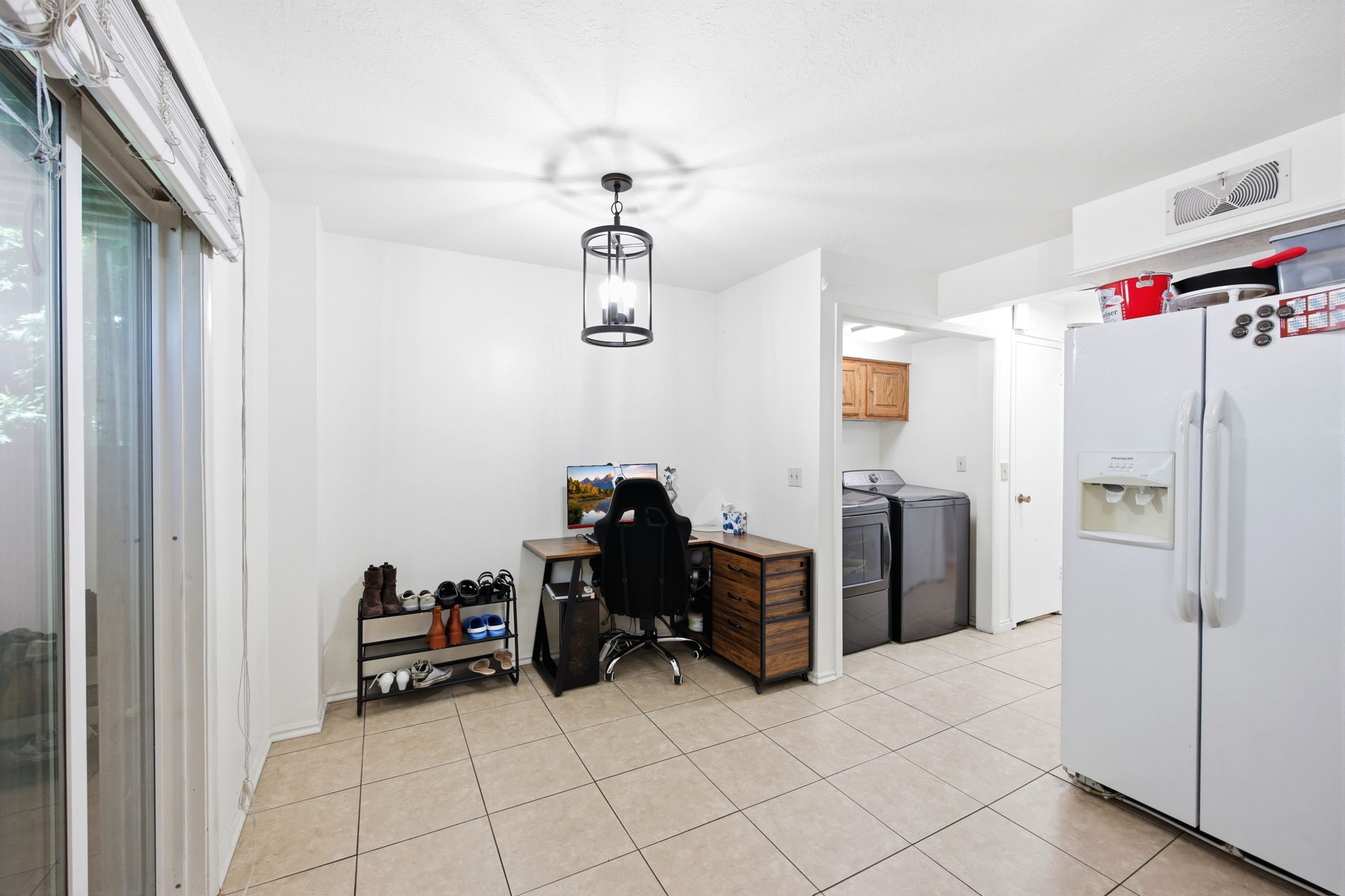 Open-concept space featuring tile flooring and a glass sliding door