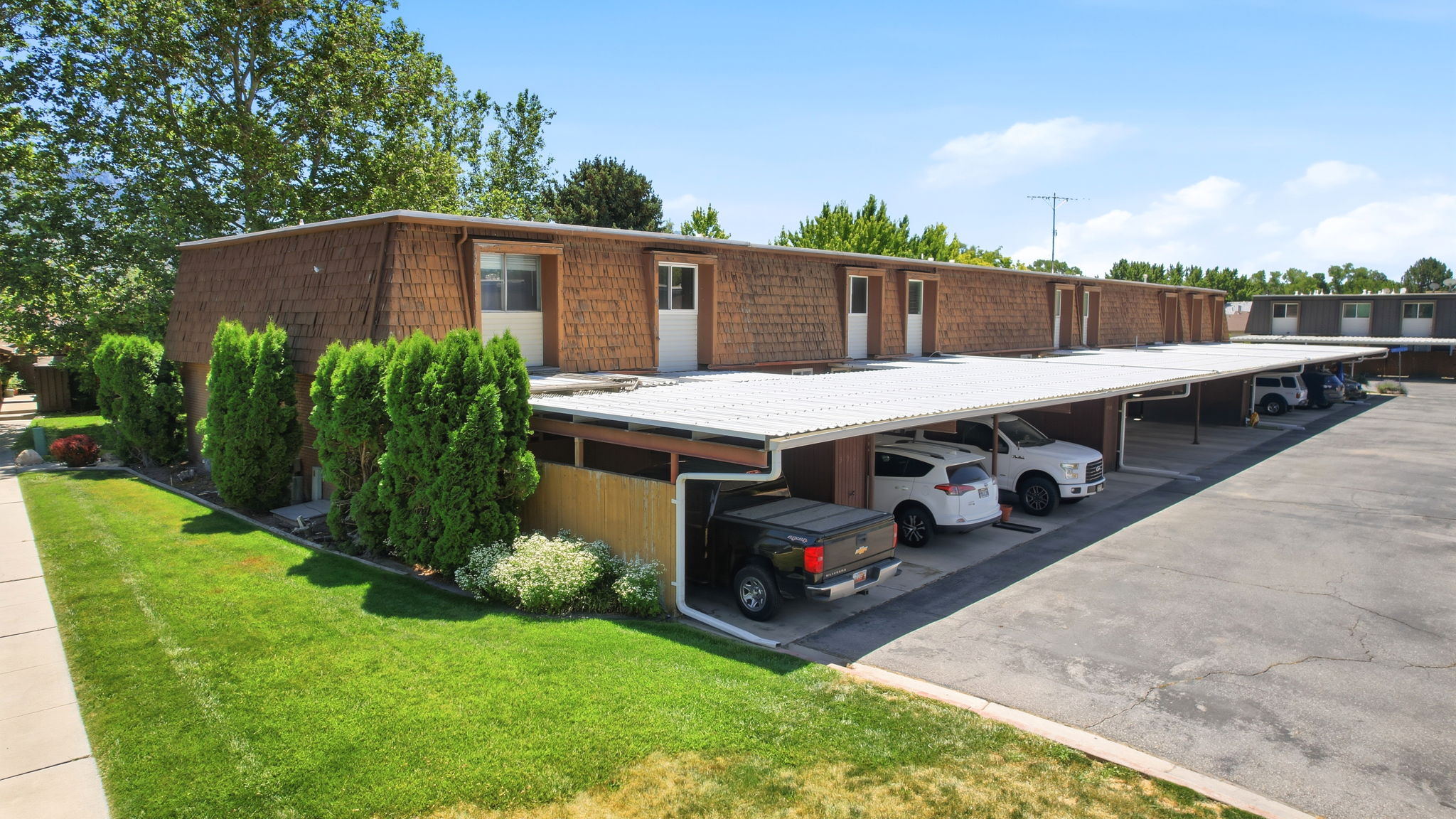 Multi-unit building featuring a wood shingle exterior and individual entry doors