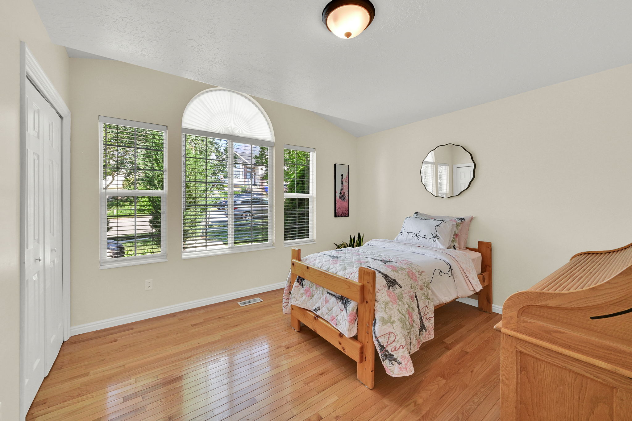 Windowed room with light wood-finish flooring