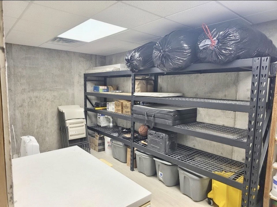 Utility room featuring concrete walls and light-toned flooring