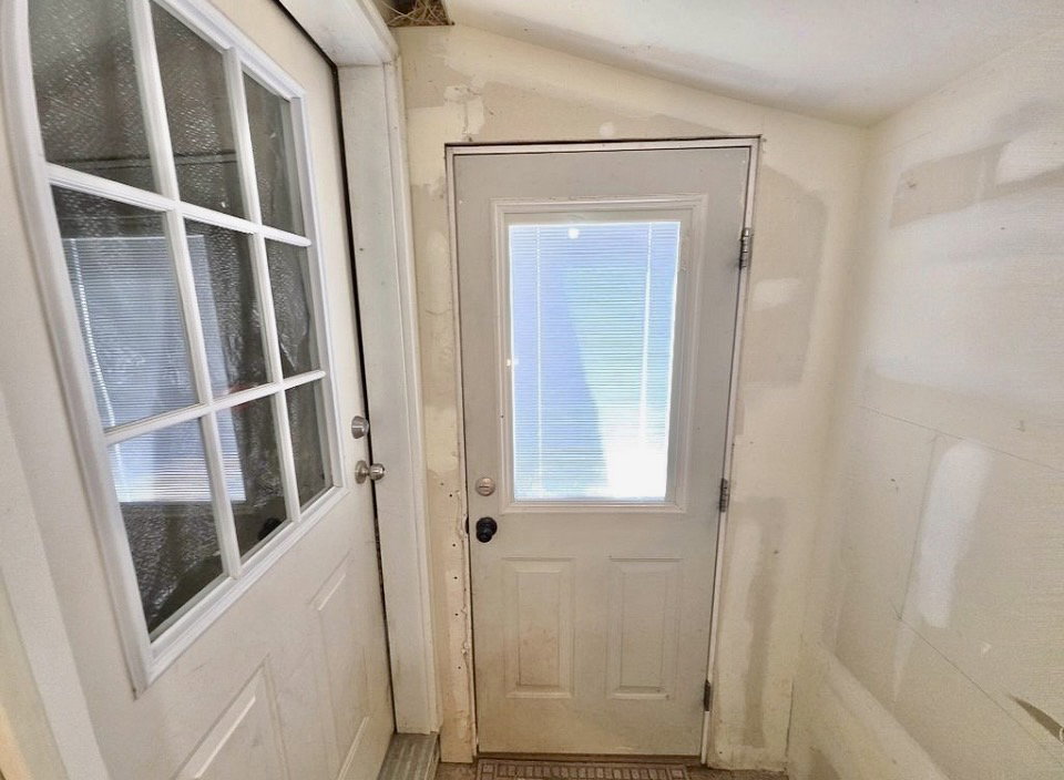 Entryway featuring two white doors