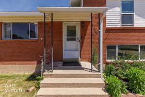 Brick exterior with white siding accents and a covered entry