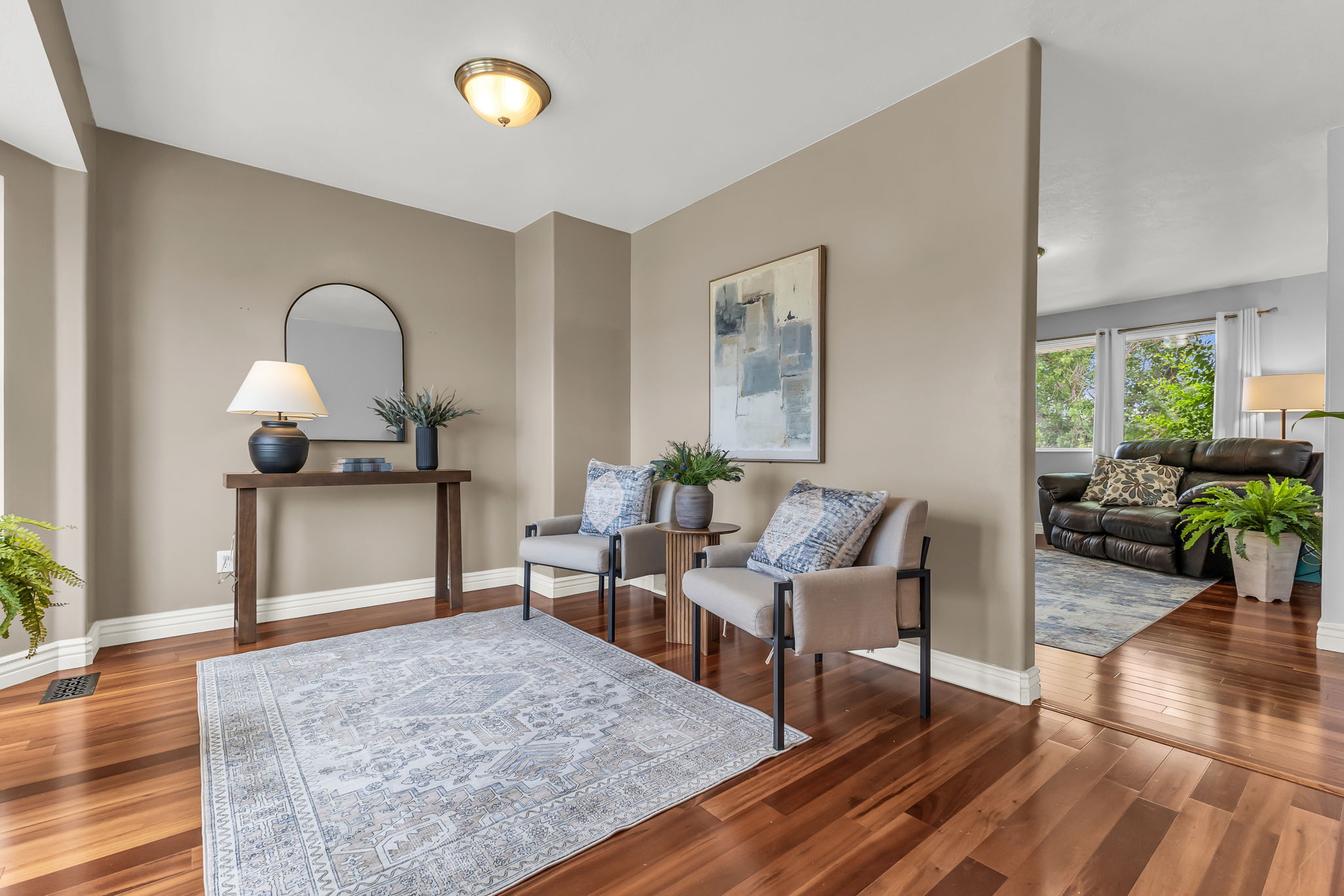 Rich wood-finish flooring extends through the entry area