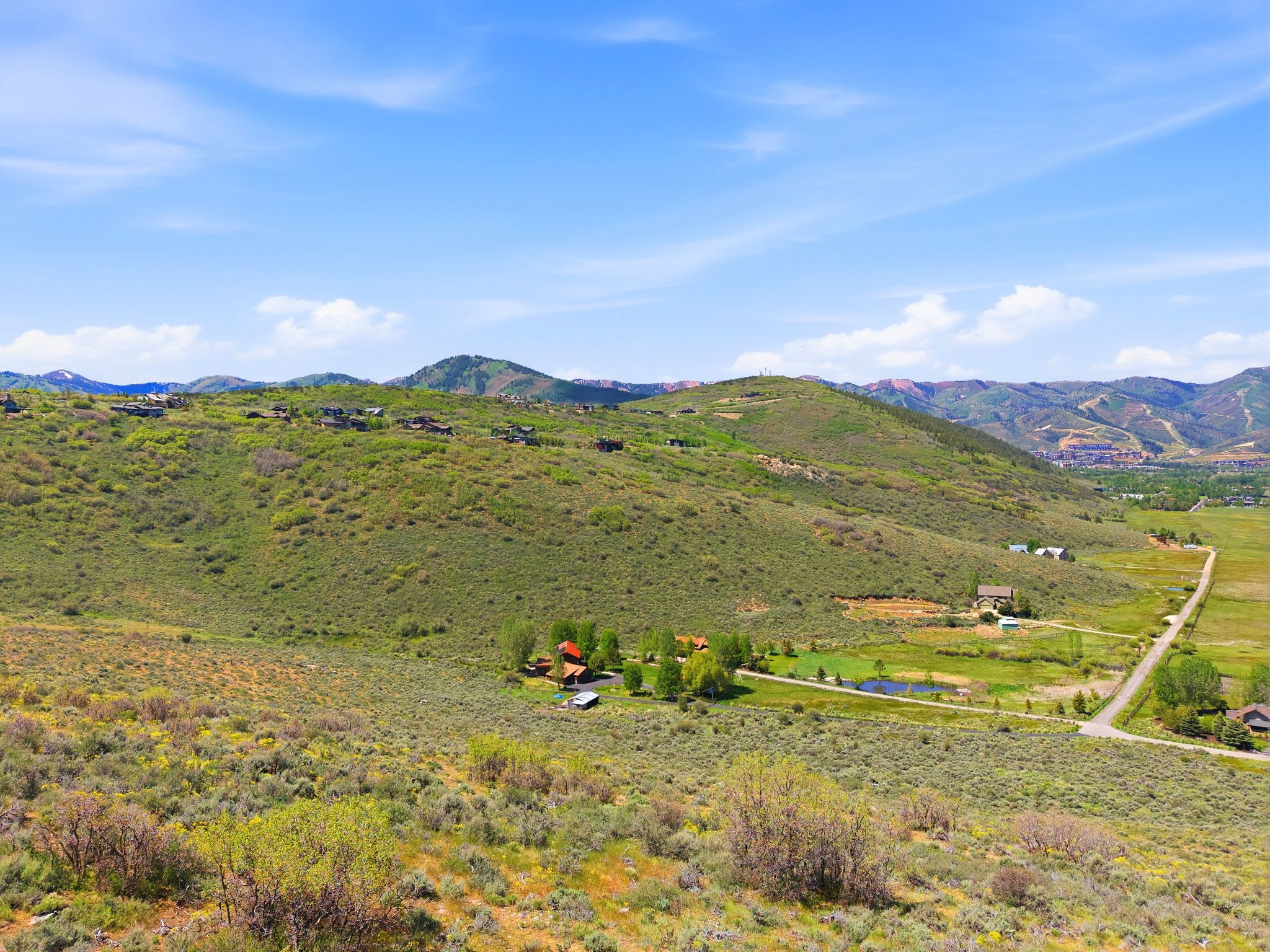 Expansive landscape featuring rolling hills and distant mountainous terrain