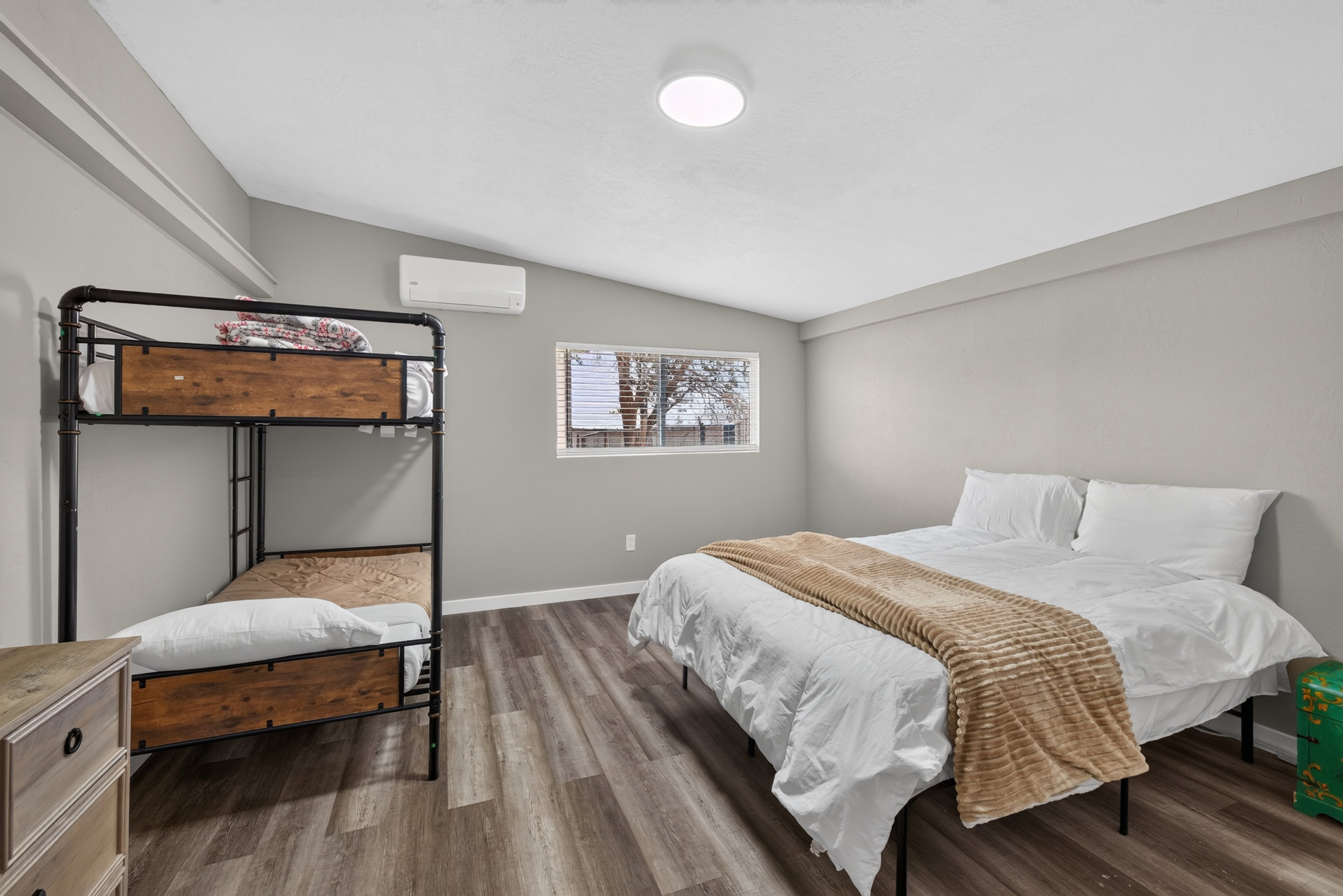 Interior space featuring wood-finish flooring, light gray wall paint, and a white ceiling with a flush-mount light fixture
