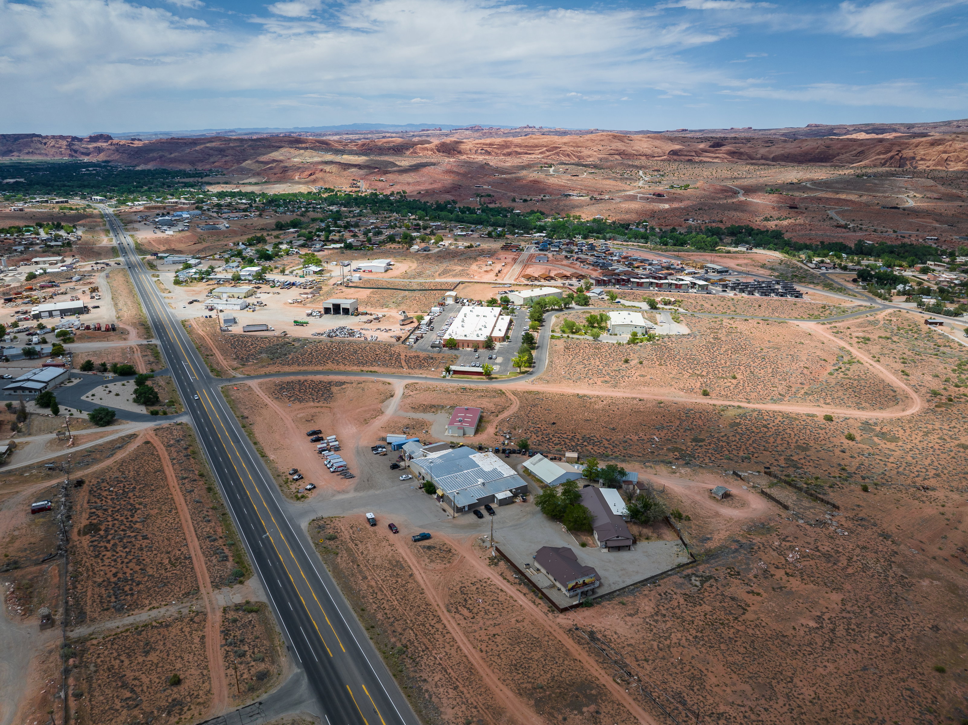 Aerial perspective of a developed area with a prominent paved road
