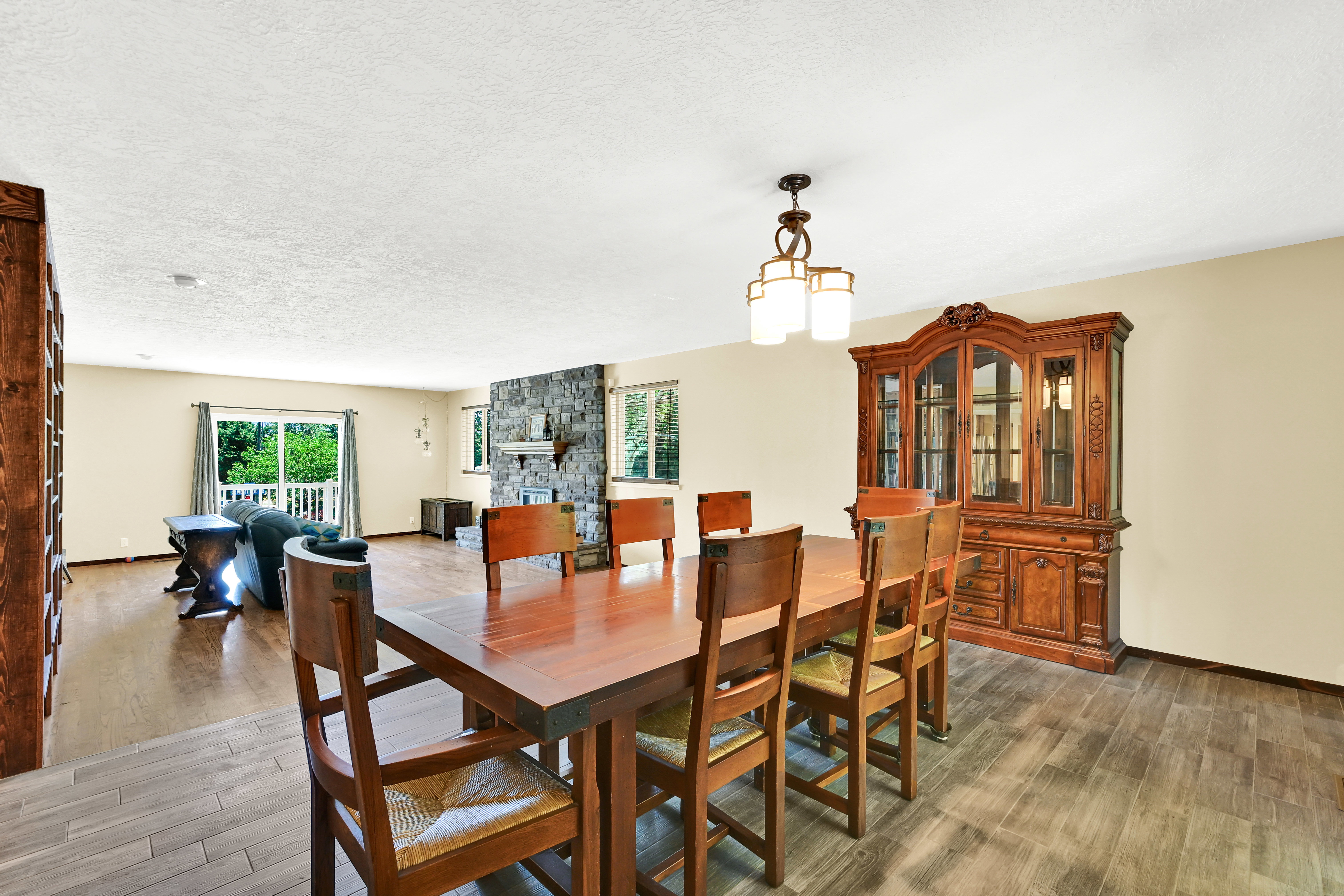 Spacious interior featuring a stone-clad fireplace and light-colored walls