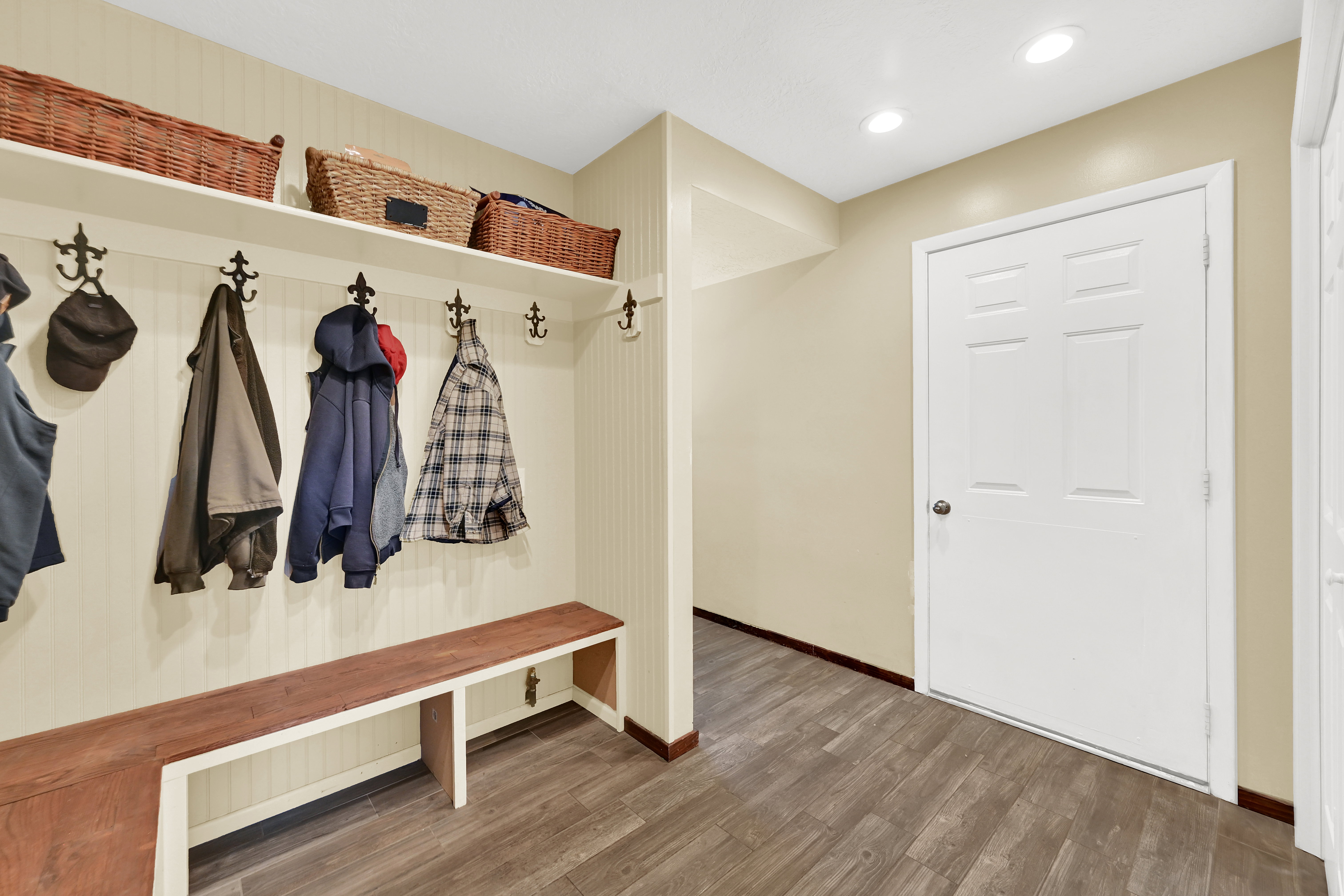 Mudroom featuring wood-finish flooring and cream-colored walls