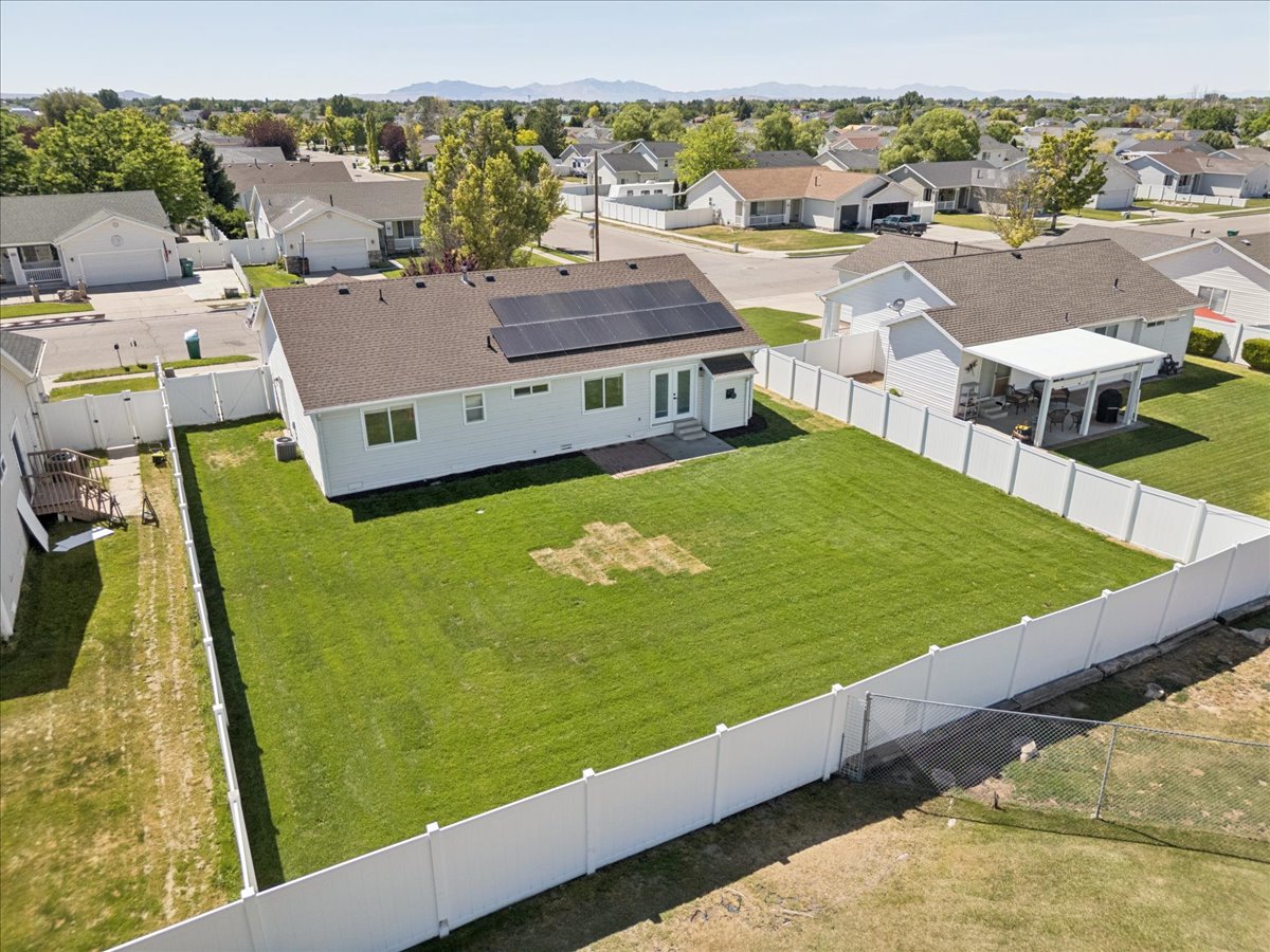 Spacious backyard featuring a manicured lawn and complete privacy fencing