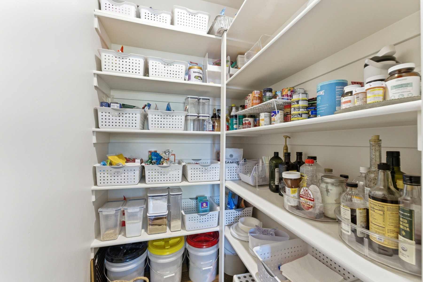 Built-in pantry shelving with white painted surfaces