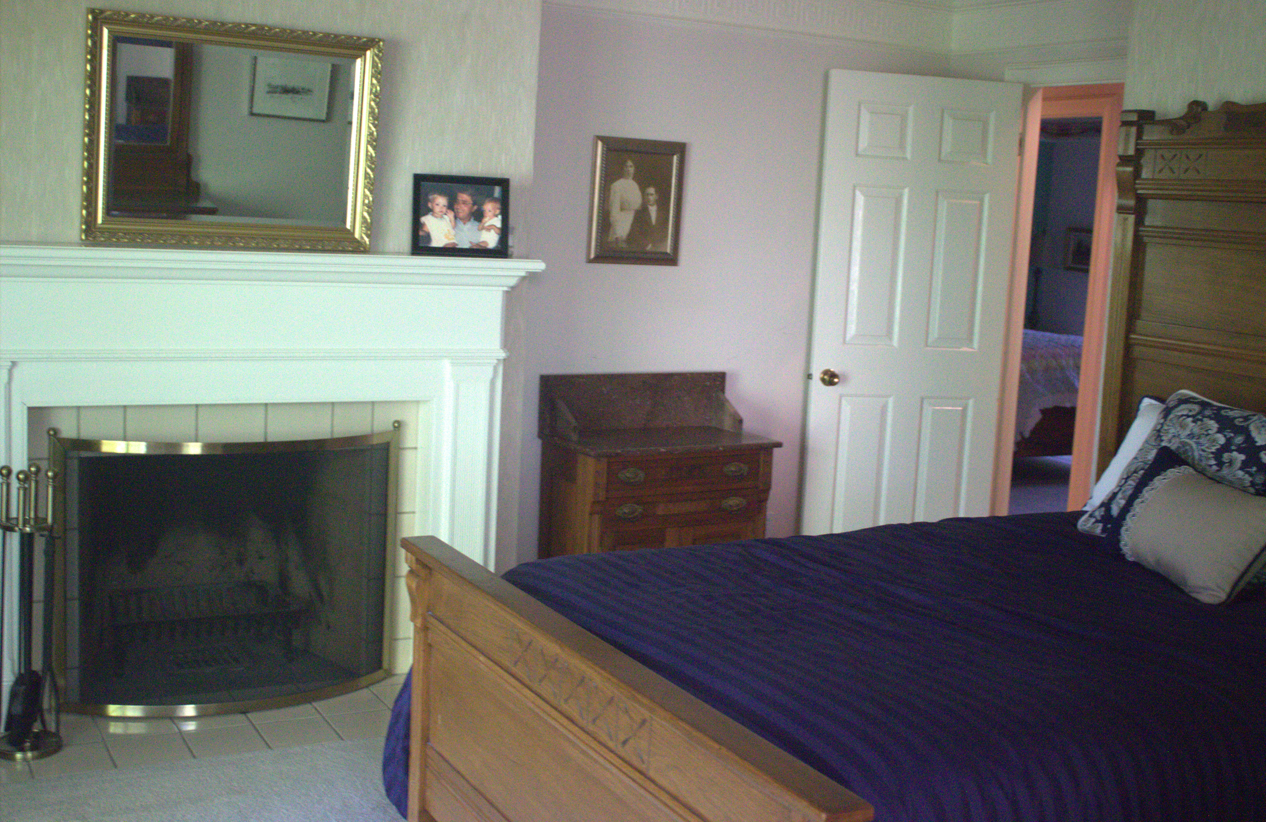Fireplace with white mantel and tile surround