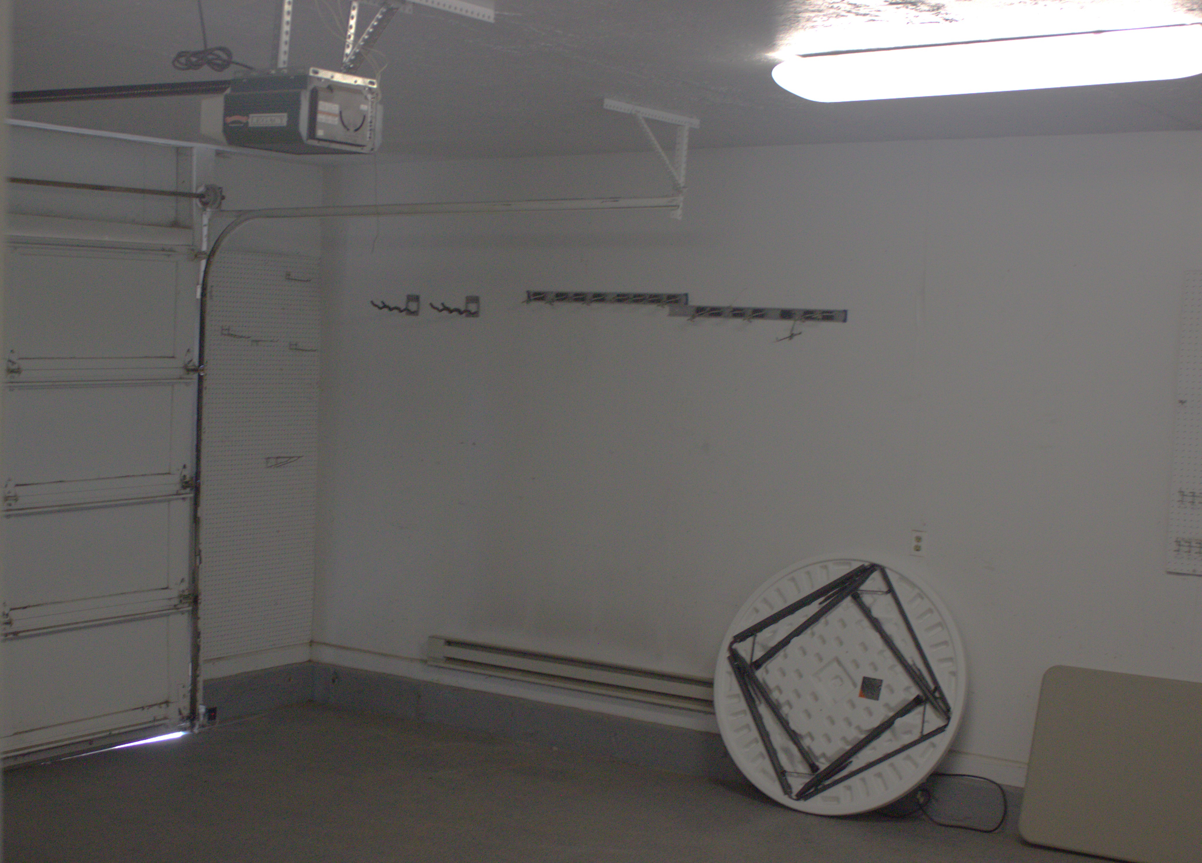 Attached garage featuring a concrete floor and a white paneled garage door with an automatic opener