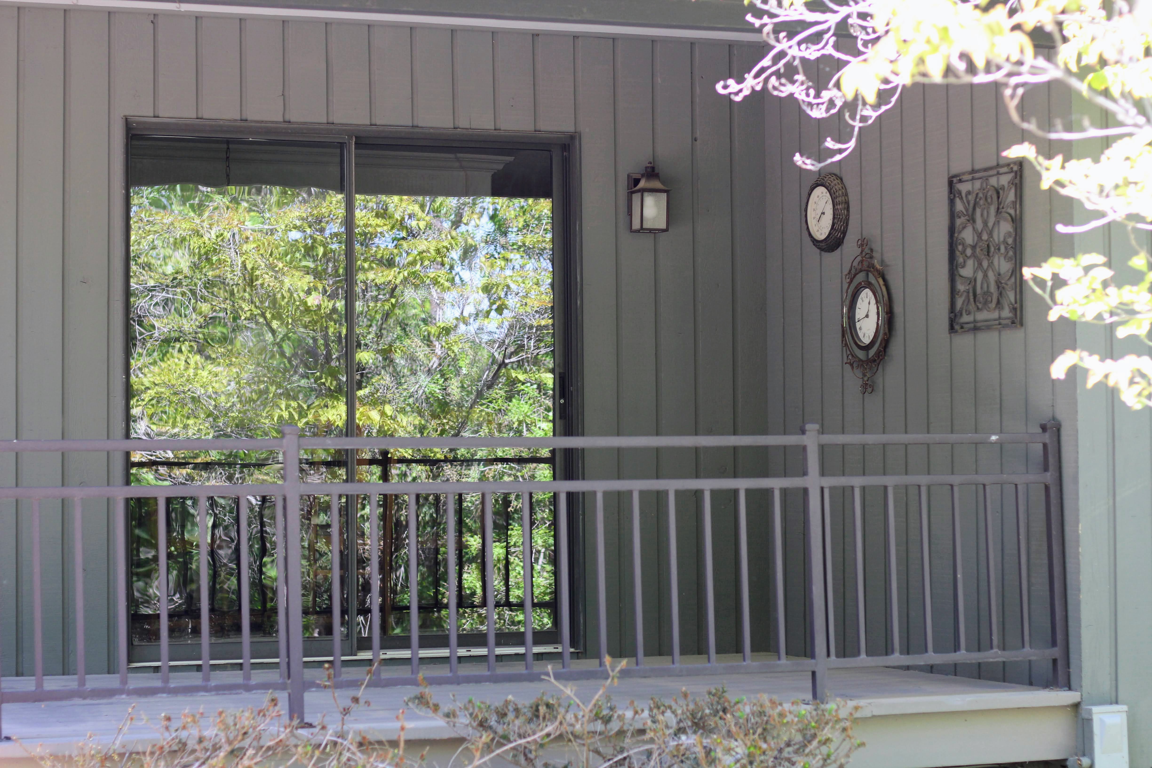 Exterior balcony featuring metal railings and a sliding glass door