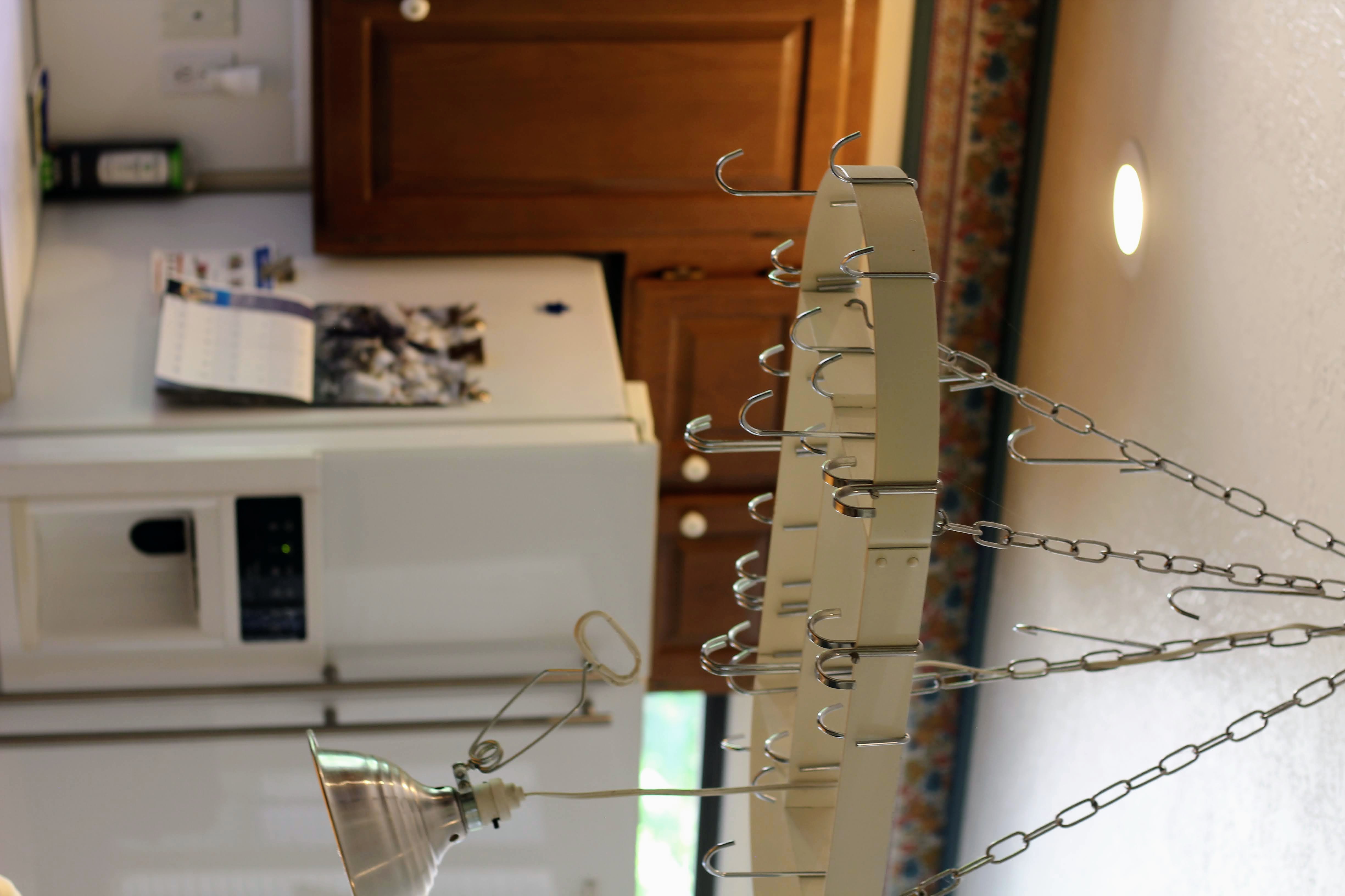 Ceiling-mounted pot rack with integrated hooks