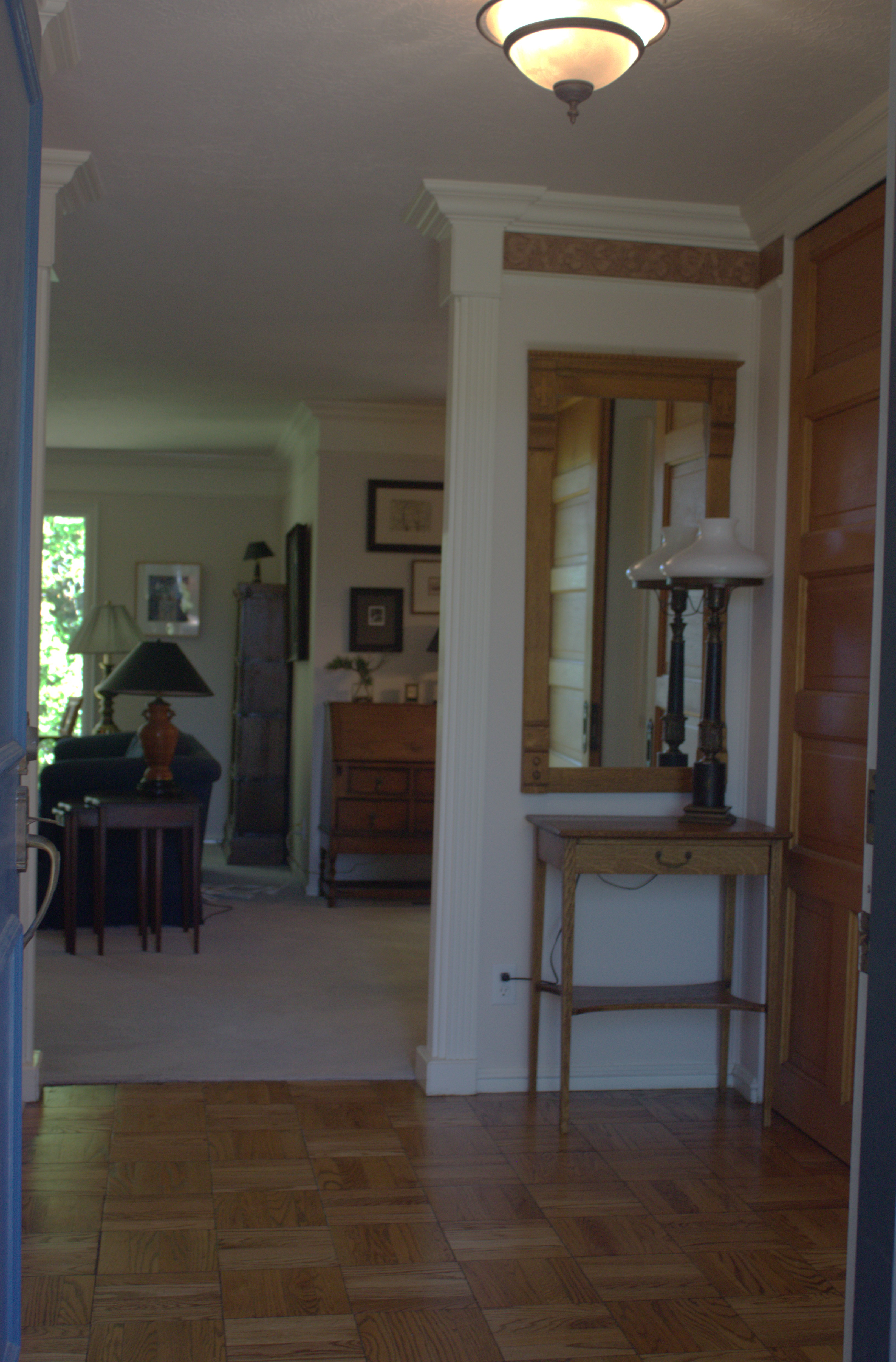 Entryway featuring parquet wood-finish flooring, white trim, and a semi-flush ceiling fixture