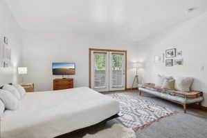 Light-filled room featuring double French doors with exterior access, wood-finish trim, and recessed lighting
