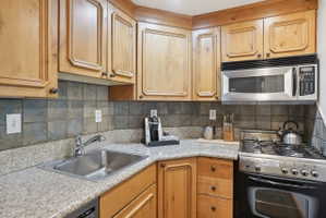 Corner kitchen with wood cabinetry and light-colored countertops