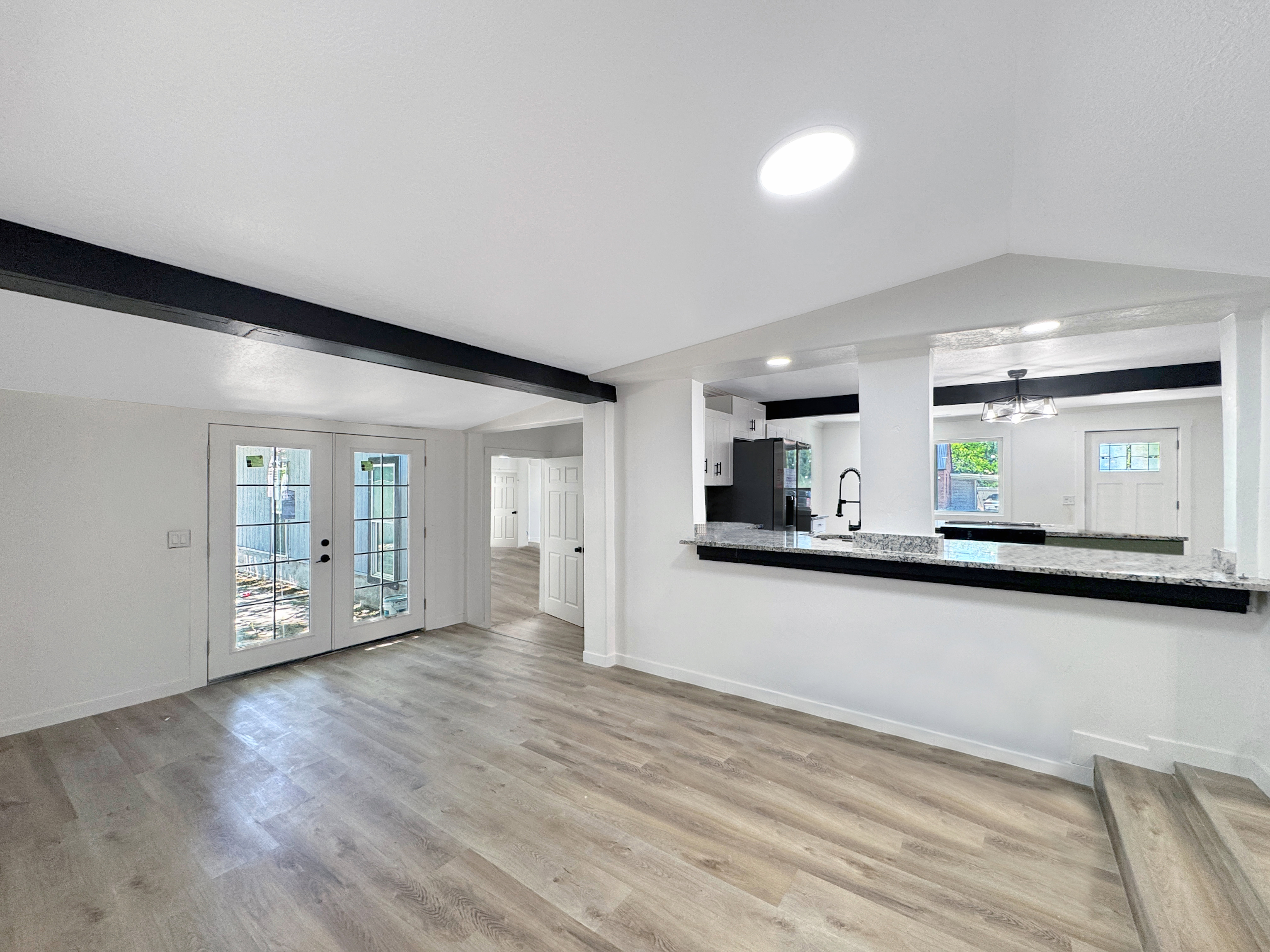 Spacious interior featuring light wood-finish flooring and a bright, neutral color palette