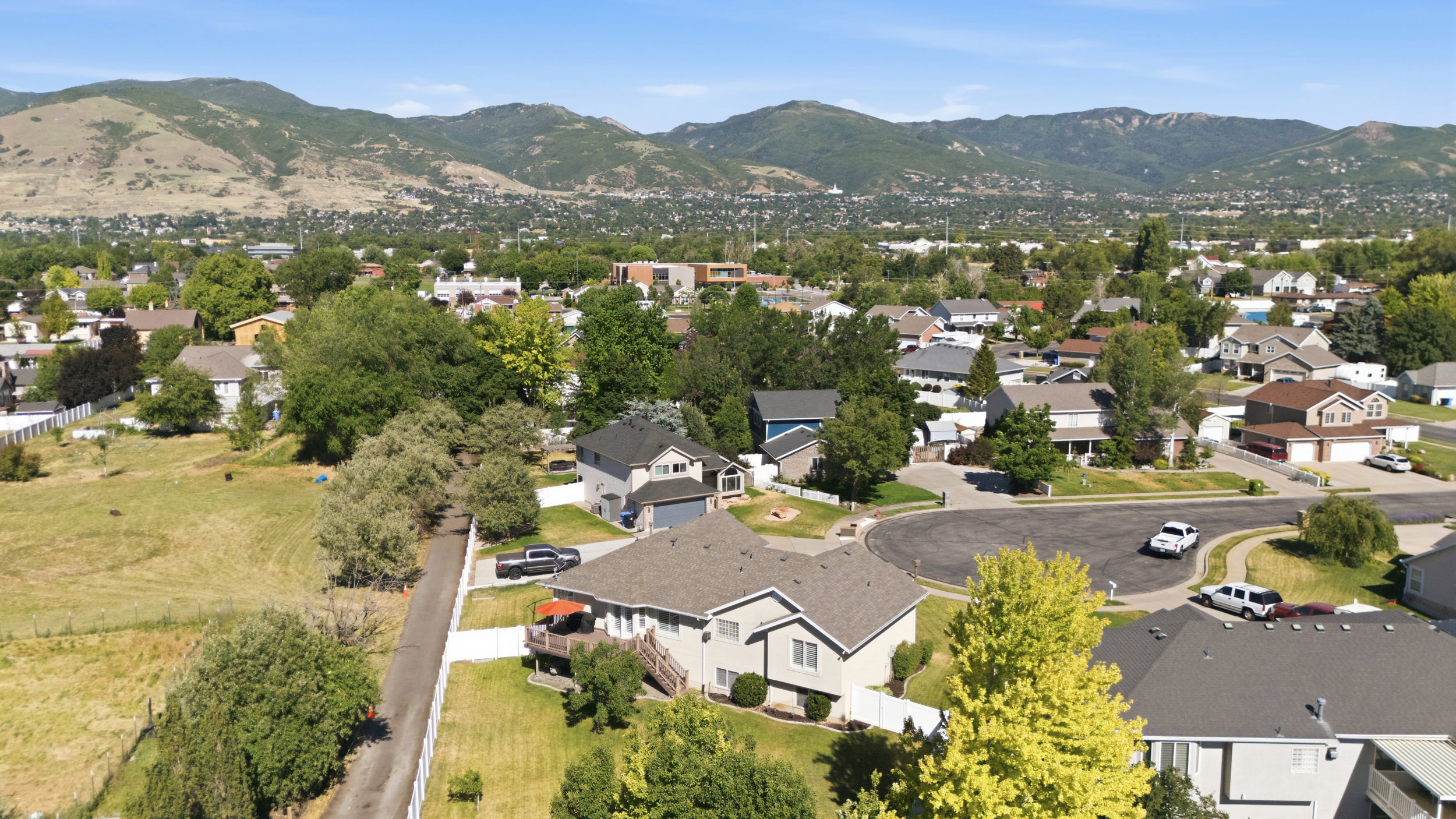 Aerial perspective showcasing residential properties with a mountainous backdrop