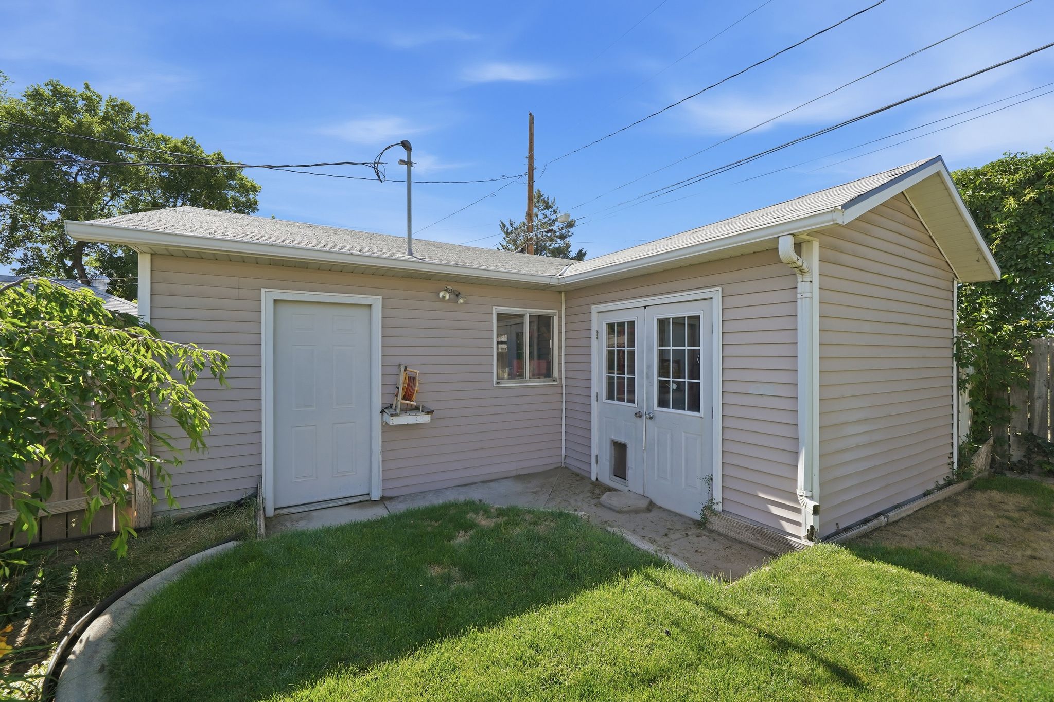 Exterior structure featuring horizontal siding, white trim, and a gabled roofline