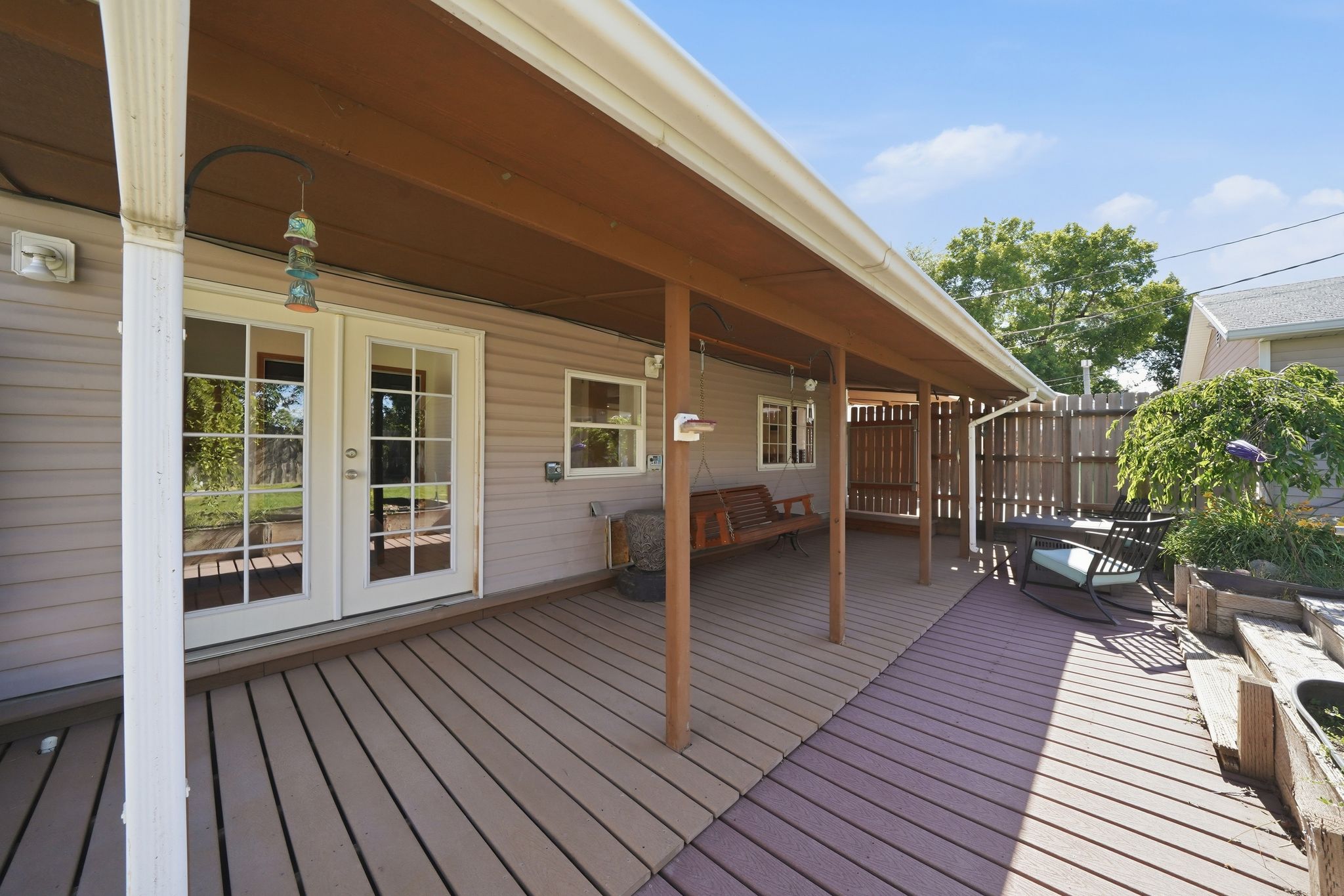 Expansive covered deck featuring wood-finish flooring
