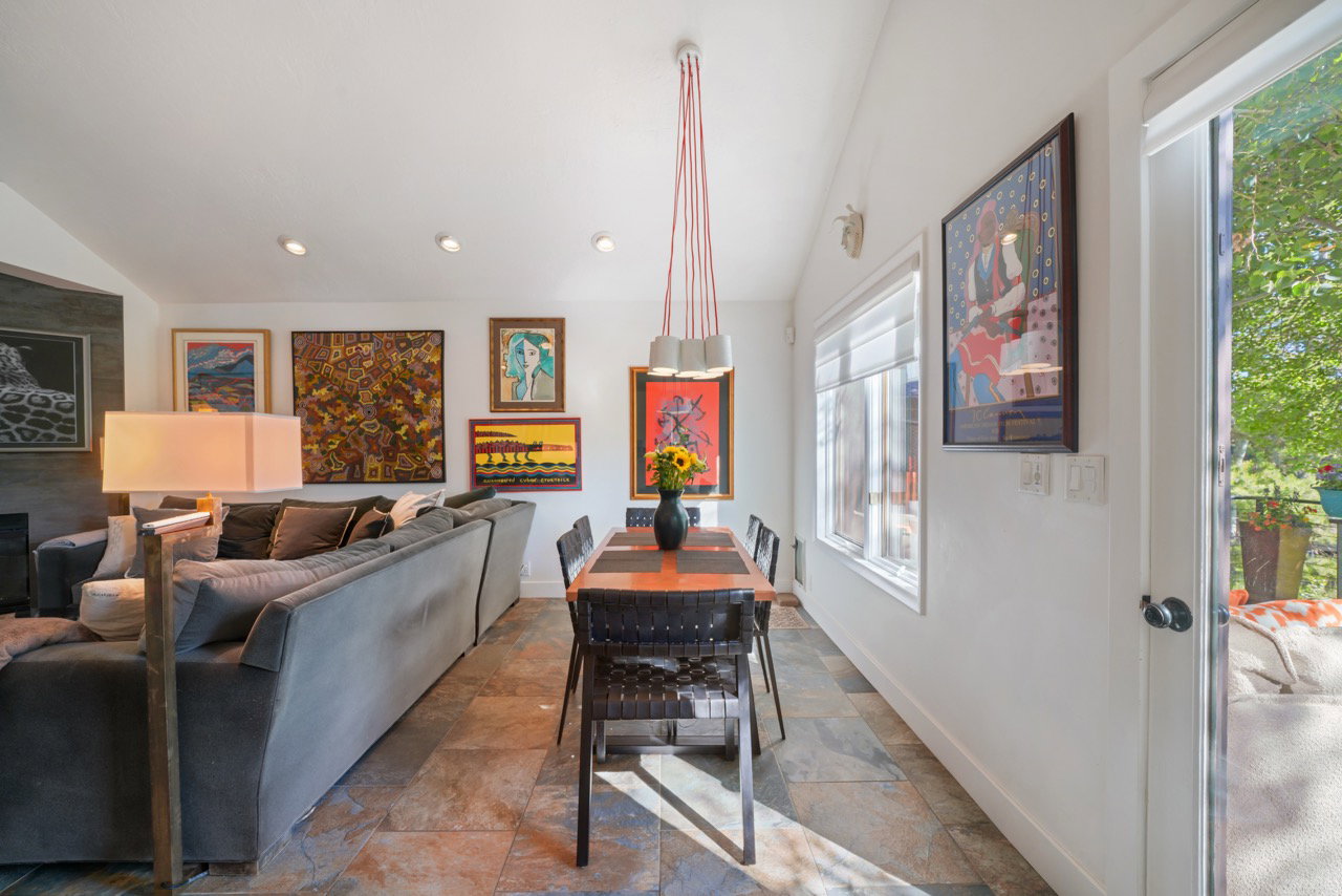 Open-concept living and dining area featuring slate tile flooring