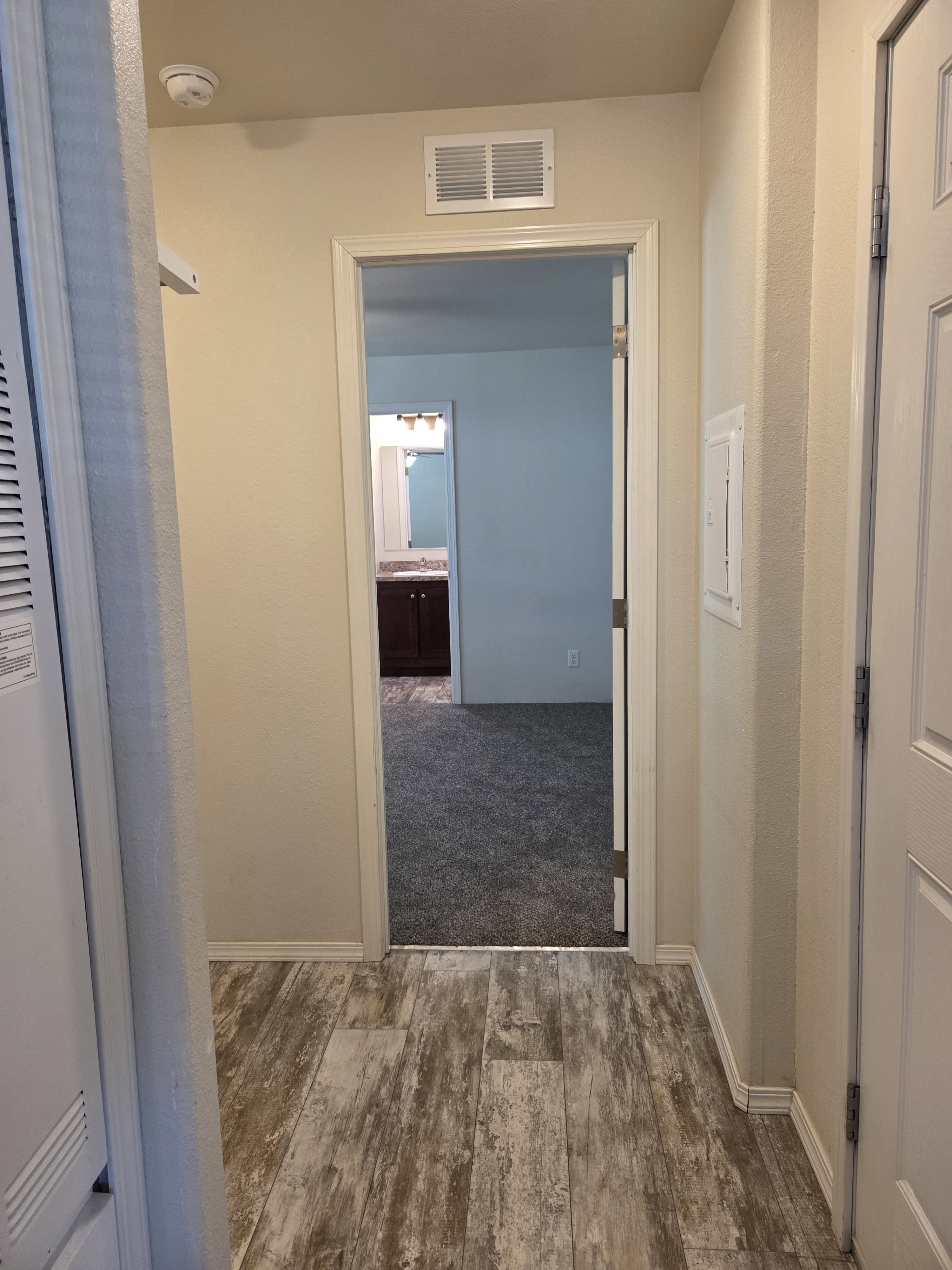 Laundry room off of the hallway, between the kitchen and the master bedroom.