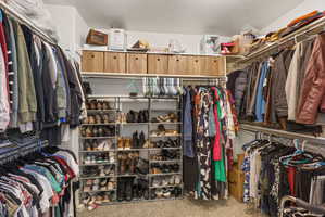 Customizable walk-in closet featuring multiple hanging rods, integrated shelving, and dedicated shoe racks