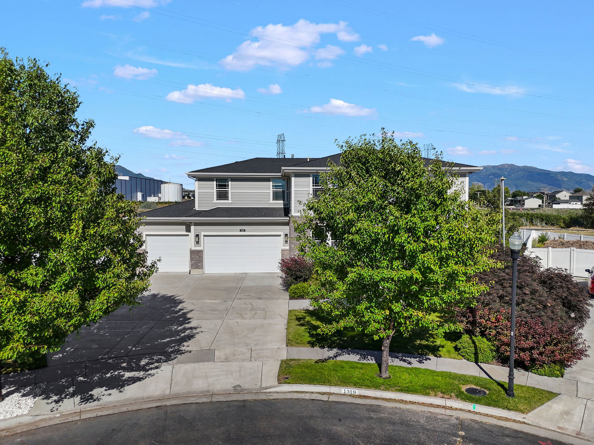 Two-story residence featuring gray siding and a dark roof
