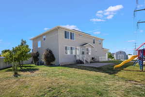Rear exterior featuring stucco siding, a ground-level concrete patio, and a white deck with railings