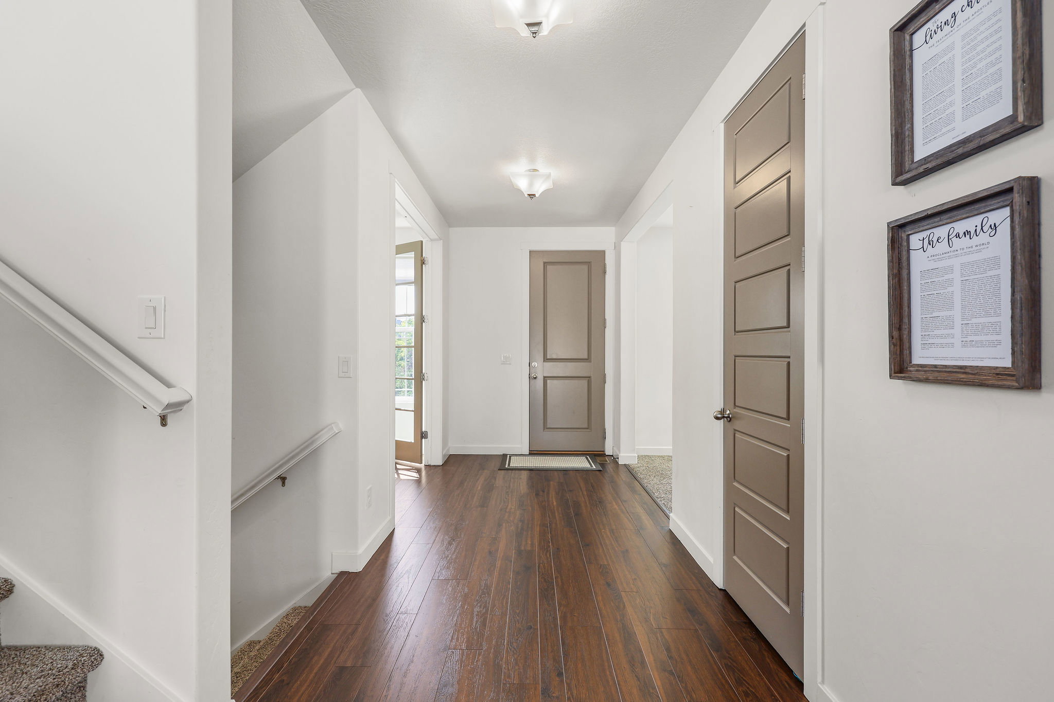 Entryway featuring rich wood-finish flooring, white baseboards, and neutral wall tones