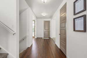 Entryway featuring rich wood-finish flooring, white baseboards, and neutral wall tones
