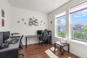 Bright room featuring two large windows with white frames and privacy blinds