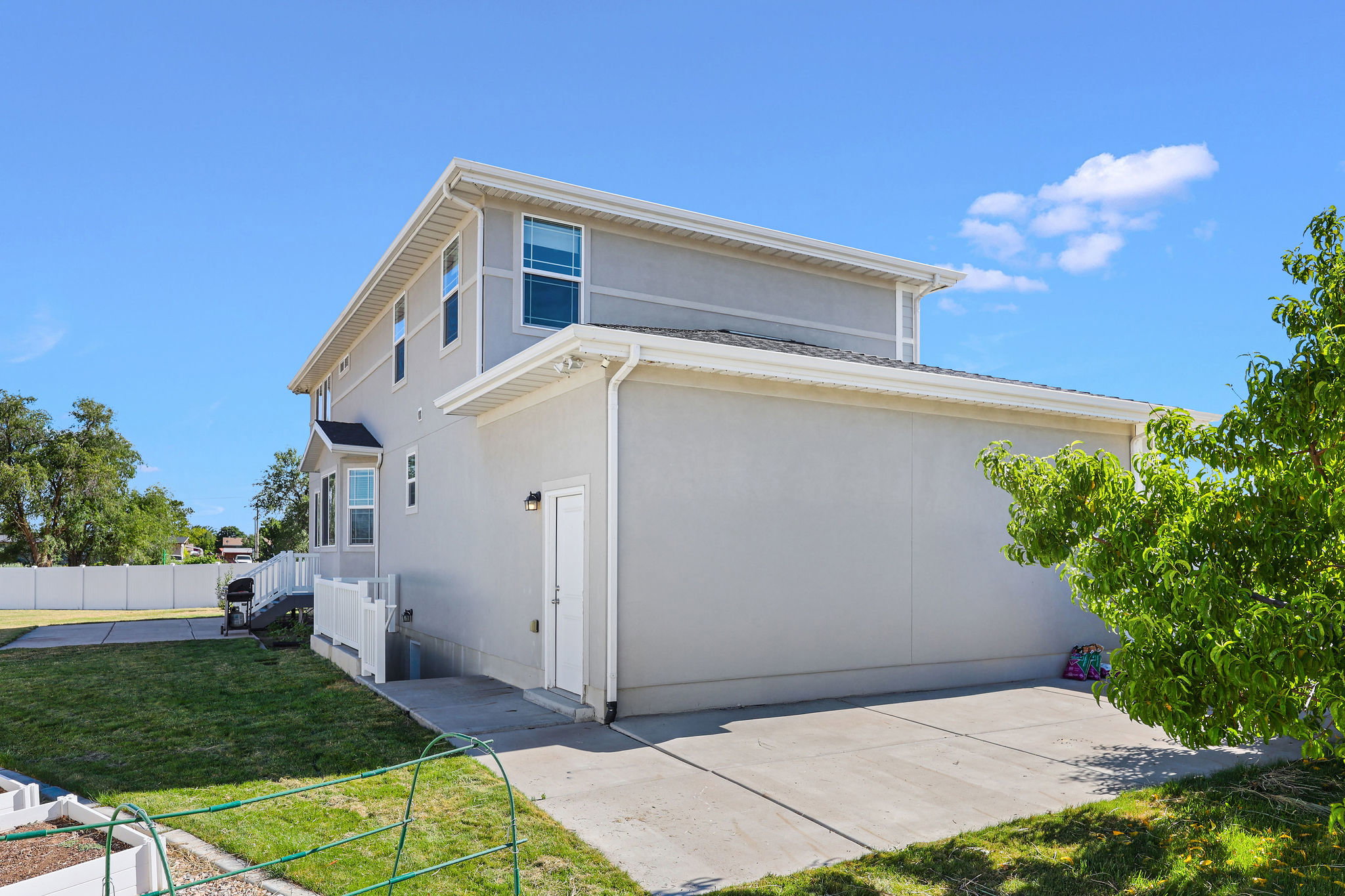 Rear exterior featuring stucco siding and a two-story design