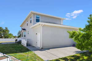 Rear exterior featuring stucco siding and a two-story design
