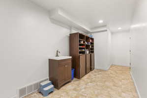 walk out basement area with a vanity sink
