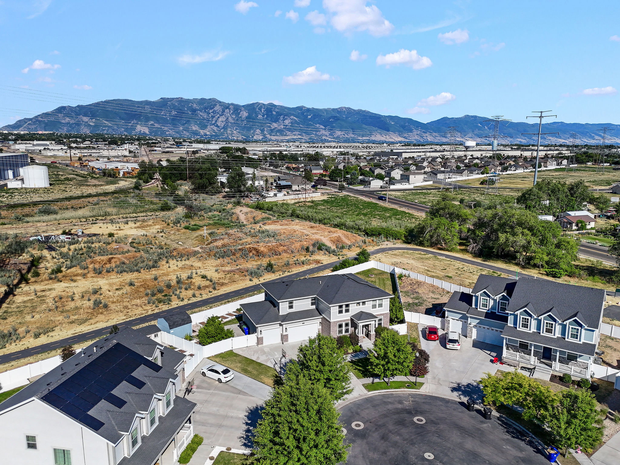 Cul-de-sac residence featuring a two-story design, attached garage, and a covered front porch