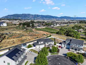 Cul-de-sac residence featuring a two-story design, attached garage, and a covered front porch