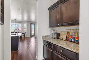 Built-in cabinetry with a granite countertop provides functional storage