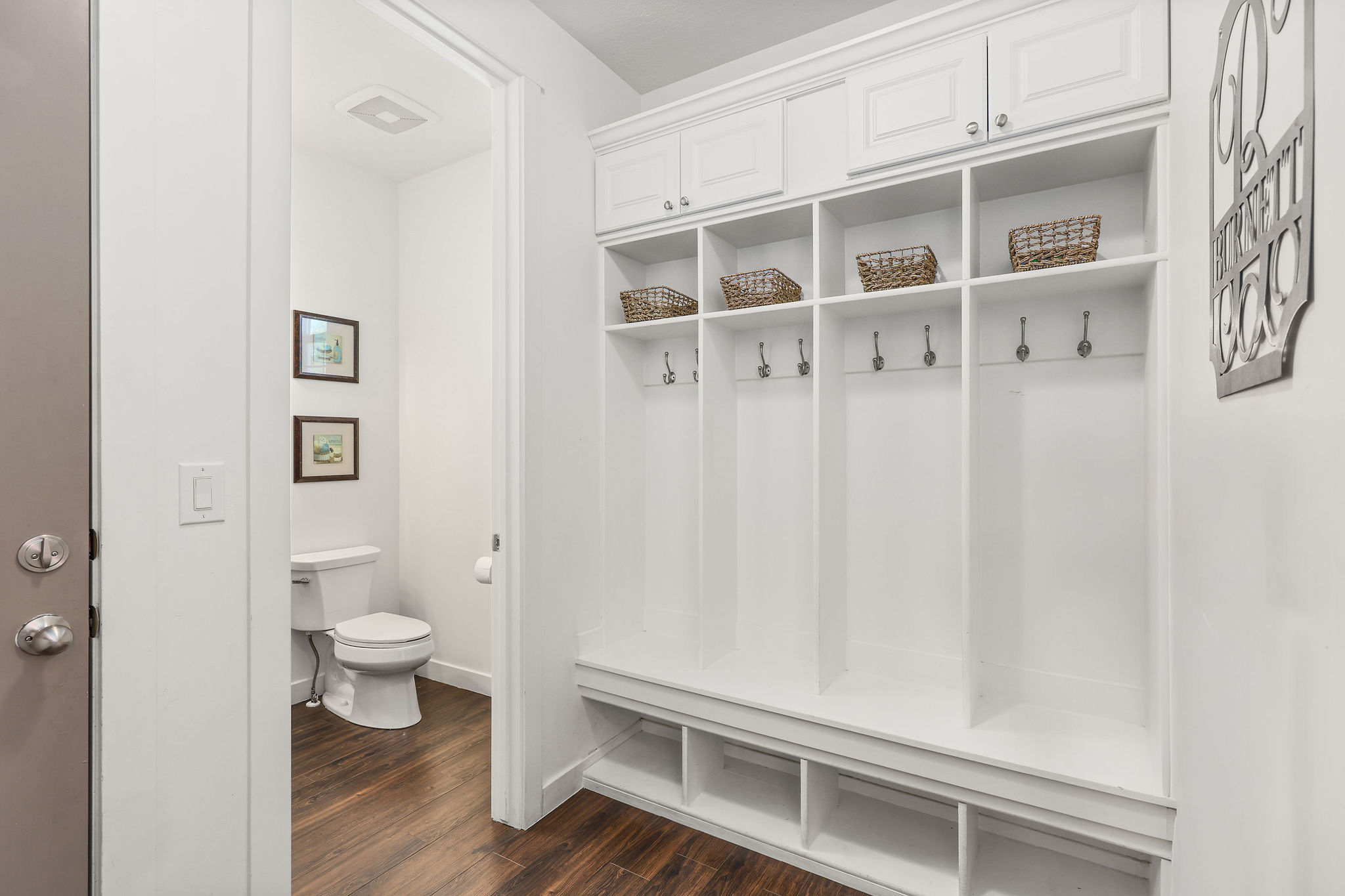 Custom built-in mudroom cabinetry with upper storage, individual cubbies, and lower shelving